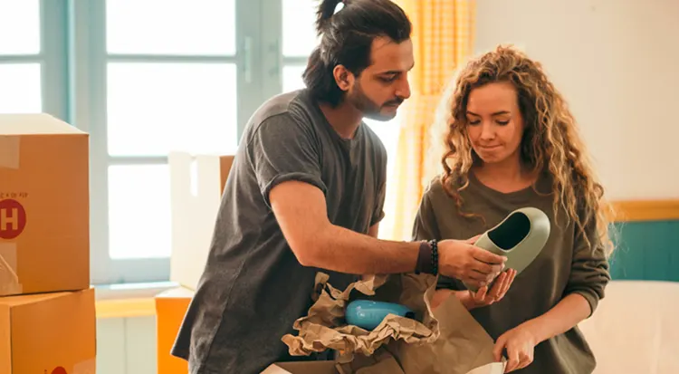 
Two friends packing a vase for the moving day